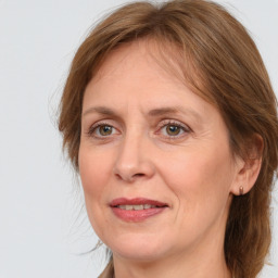 Joyful white adult female with medium  brown hair and grey eyes