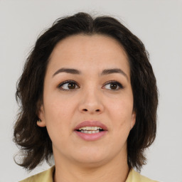 Joyful white young-adult female with medium  brown hair and brown eyes