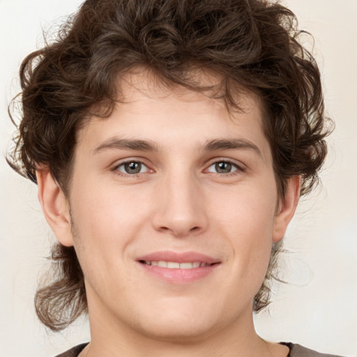 Joyful white young-adult male with medium  brown hair and brown eyes