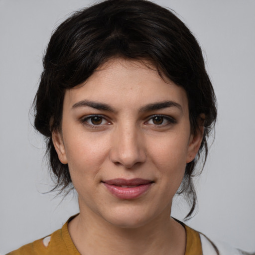 Joyful white young-adult female with medium  brown hair and brown eyes