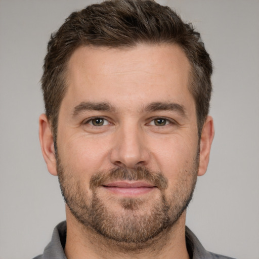 Joyful white adult male with short  brown hair and brown eyes