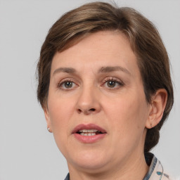 Joyful white adult female with medium  brown hair and grey eyes