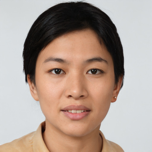Joyful asian young-adult female with short  black hair and brown eyes