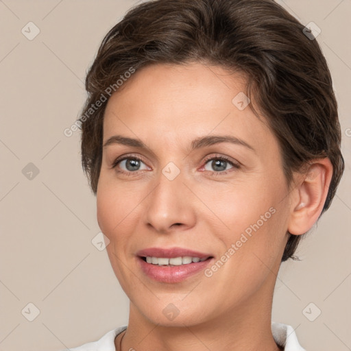 Joyful white adult female with short  brown hair and brown eyes