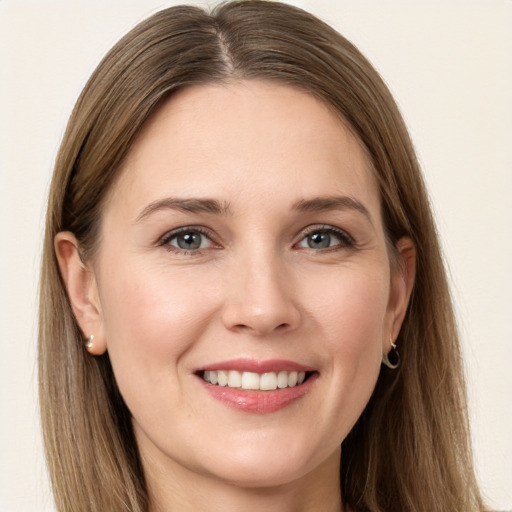 Joyful white young-adult female with long  brown hair and grey eyes