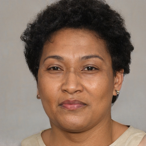 Joyful latino adult female with short  brown hair and brown eyes
