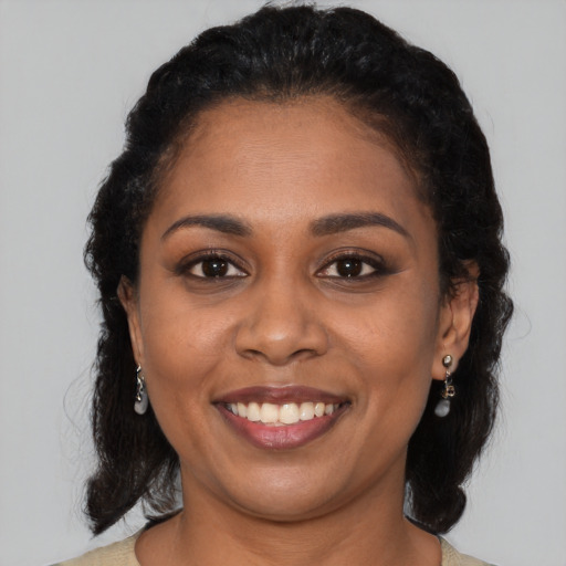 Joyful black young-adult female with medium  brown hair and brown eyes