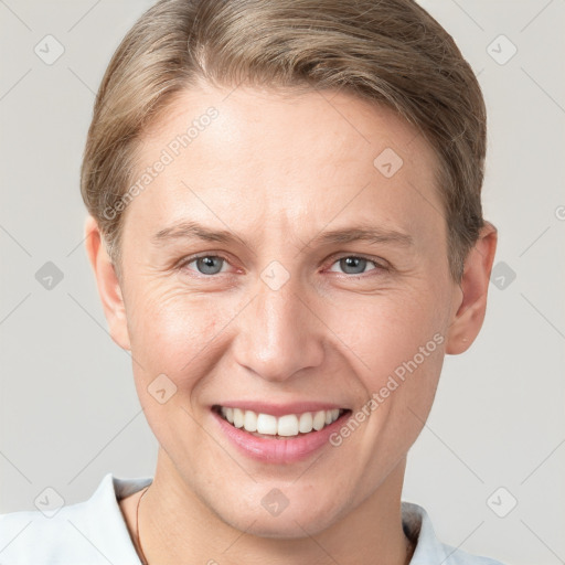 Joyful white young-adult female with short  brown hair and grey eyes