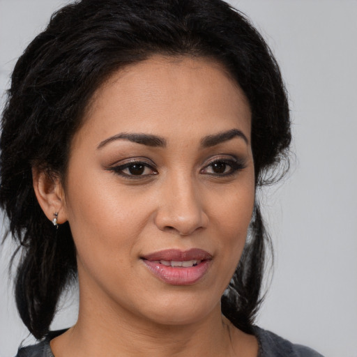 Joyful latino young-adult female with medium  brown hair and brown eyes