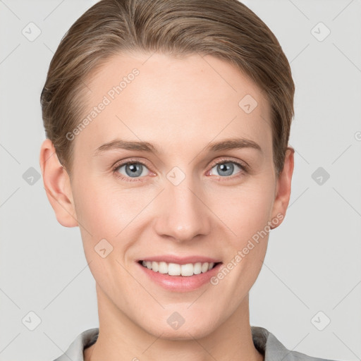 Joyful white young-adult female with short  brown hair and grey eyes