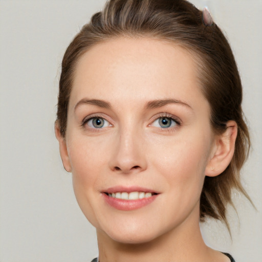 Joyful white young-adult female with medium  brown hair and grey eyes