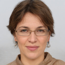 Joyful white adult female with medium  brown hair and grey eyes