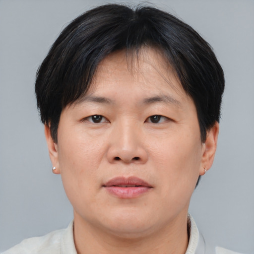 Joyful asian adult male with short  brown hair and brown eyes