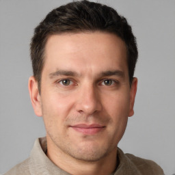 Joyful white young-adult male with short  brown hair and brown eyes