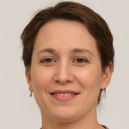 Joyful white adult female with medium  brown hair and grey eyes