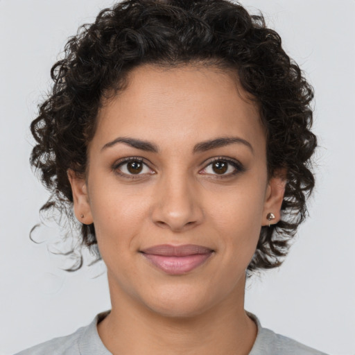 Joyful latino young-adult female with short  brown hair and brown eyes