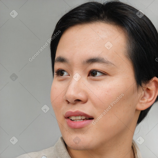 Joyful asian young-adult female with medium  brown hair and brown eyes