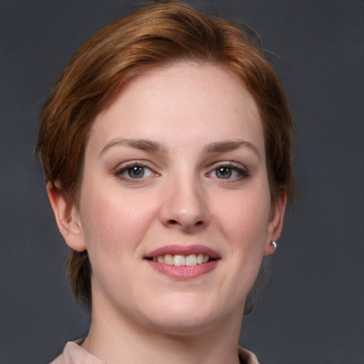 Joyful white young-adult female with medium  brown hair and blue eyes