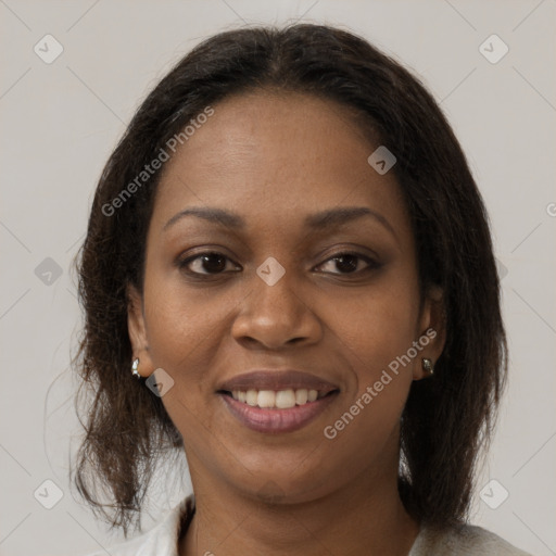 Joyful black adult female with medium  brown hair and brown eyes