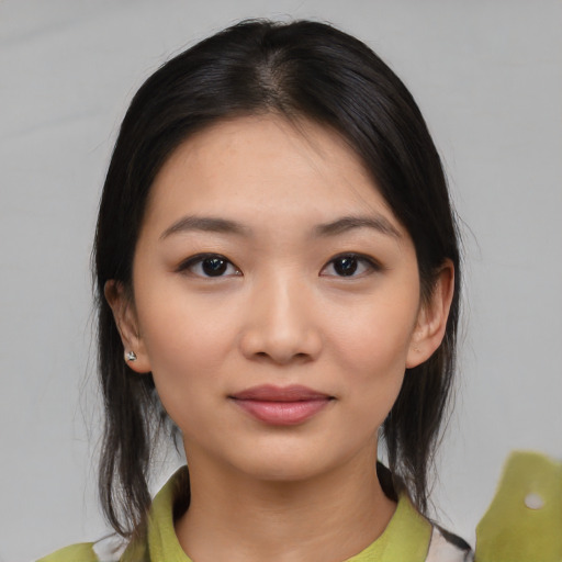 Joyful white young-adult female with medium  black hair and brown eyes