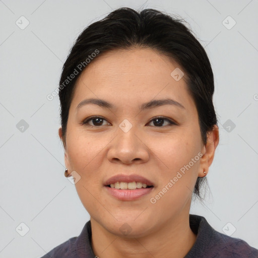 Joyful asian adult female with medium  brown hair and brown eyes