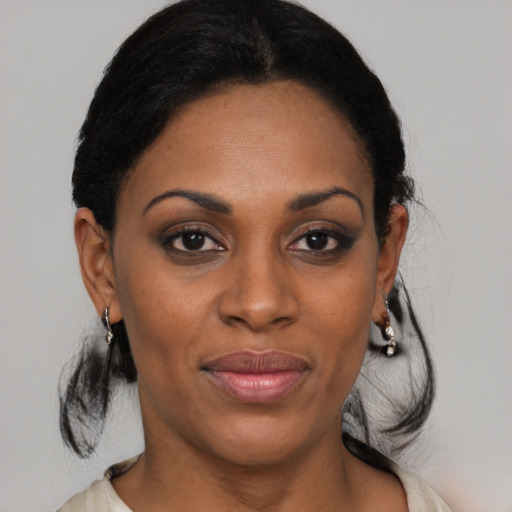 Joyful black young-adult female with medium  brown hair and brown eyes