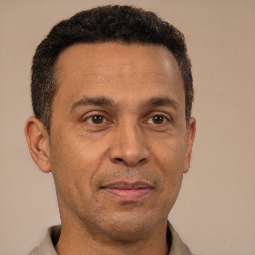 Joyful latino adult male with short  brown hair and brown eyes