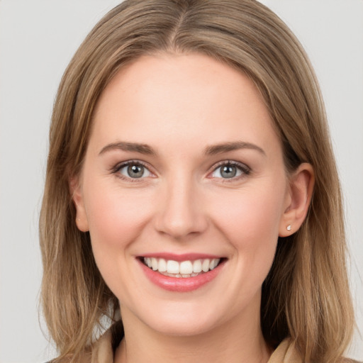 Joyful white young-adult female with long  brown hair and grey eyes