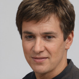 Joyful white adult male with short  brown hair and brown eyes