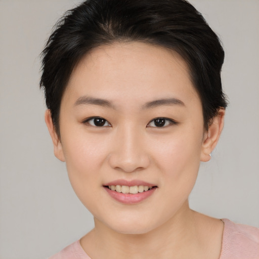 Joyful asian young-adult female with short  brown hair and brown eyes