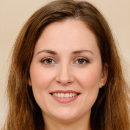 Joyful white young-adult female with long  brown hair and green eyes