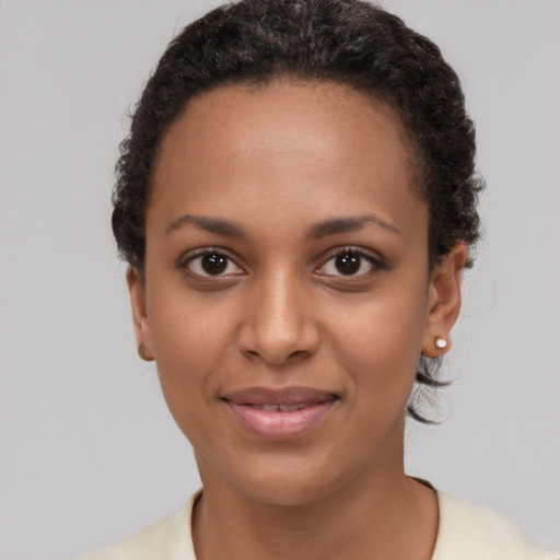 Joyful black young-adult female with short  brown hair and brown eyes