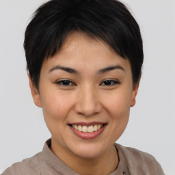 Joyful asian young-adult female with short  brown hair and brown eyes