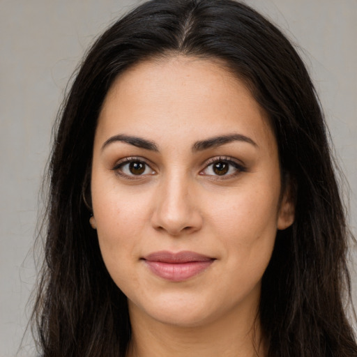 Joyful white young-adult female with long  brown hair and brown eyes