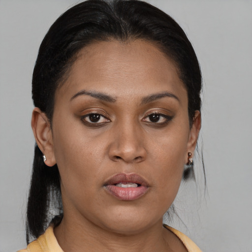 Joyful latino young-adult female with medium  brown hair and brown eyes