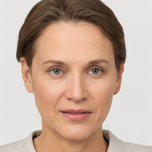 Joyful white adult female with short  brown hair and grey eyes