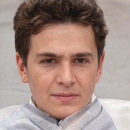 Joyful white adult male with short  brown hair and grey eyes