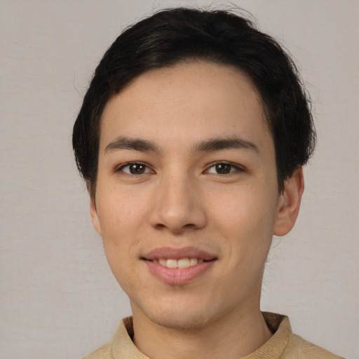 Joyful white young-adult male with short  black hair and brown eyes