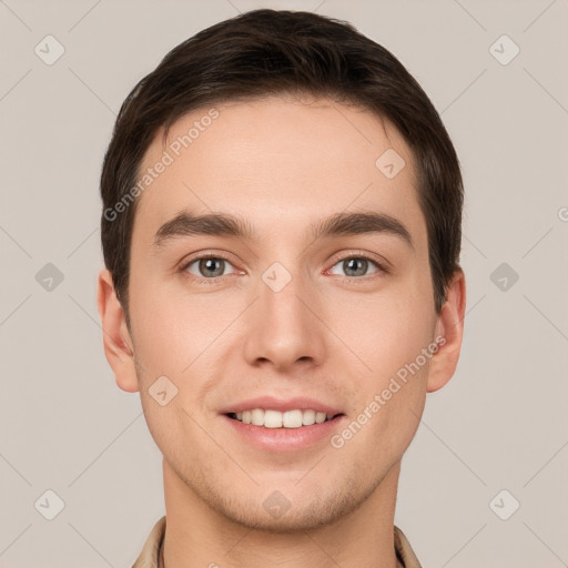 Joyful white young-adult male with short  brown hair and grey eyes