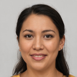 Joyful latino young-adult female with medium  brown hair and brown eyes