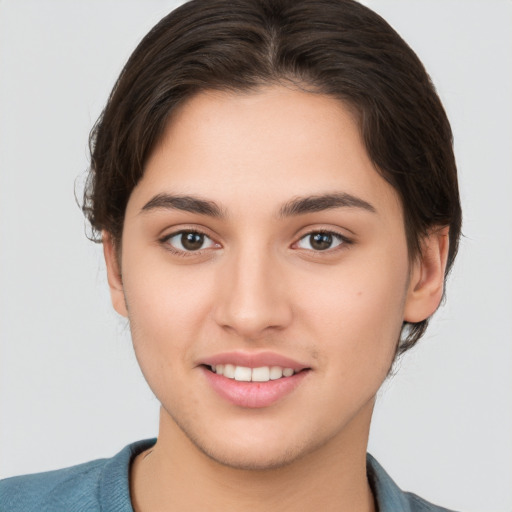 Joyful white young-adult female with short  brown hair and brown eyes