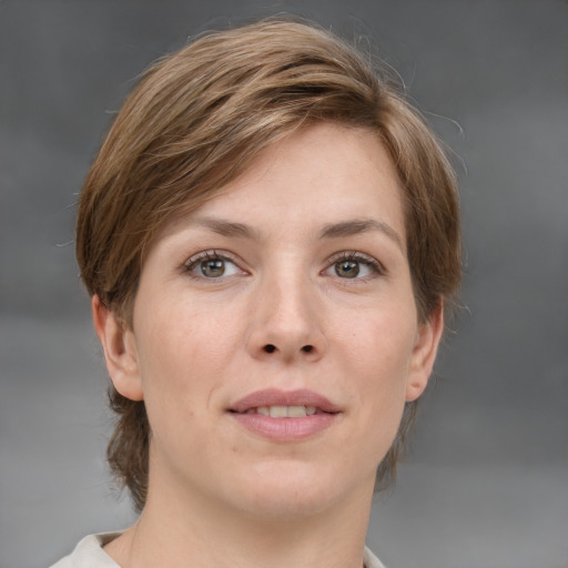 Joyful white young-adult female with medium  brown hair and grey eyes