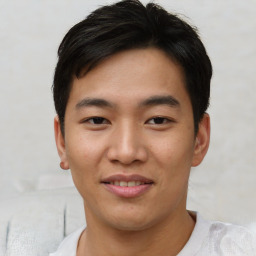 Joyful asian young-adult male with short  black hair and brown eyes