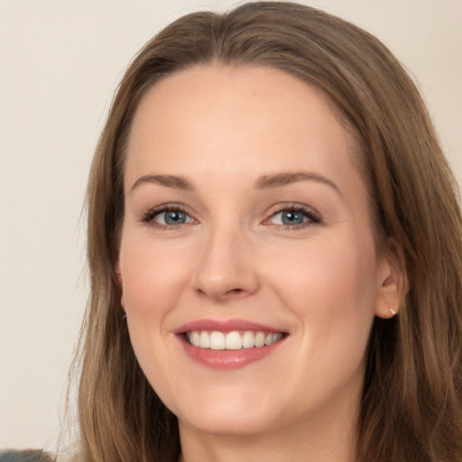 Joyful white young-adult female with long  brown hair and grey eyes