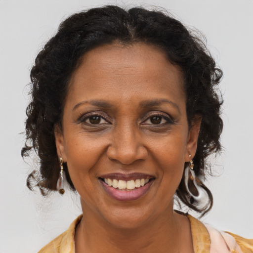 Joyful latino adult female with medium  brown hair and brown eyes
