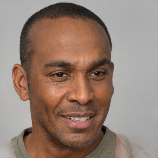 Joyful black adult male with short  black hair and brown eyes