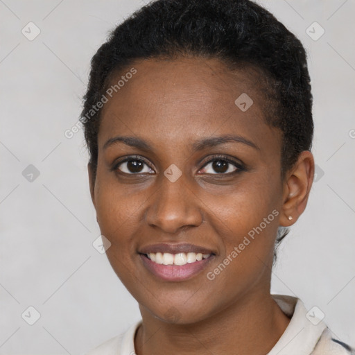 Joyful black young-adult female with short  brown hair and brown eyes