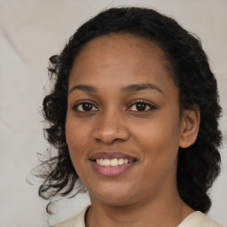 Joyful black young-adult female with medium  brown hair and brown eyes