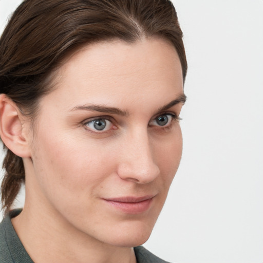 Joyful white young-adult female with medium  brown hair and blue eyes