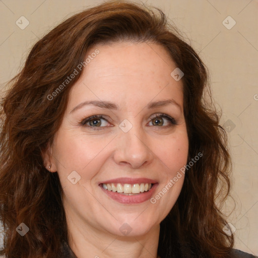 Joyful white adult female with long  brown hair and brown eyes